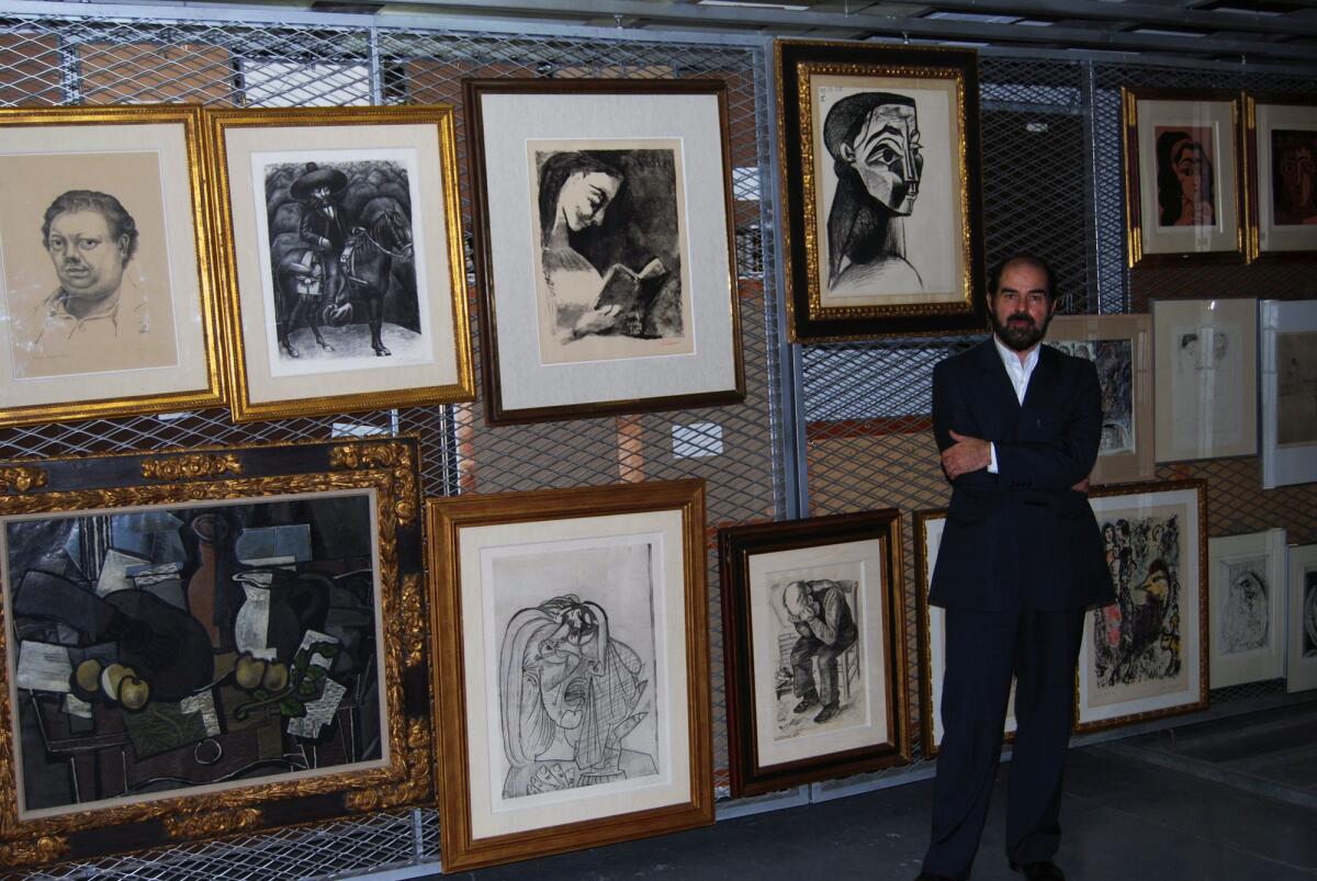 A 2012 photo shows Habibollah Sadegh, then-director of the Tehran Museum of Contemporary Art, standing beside Pablo Picasso's "Portrait de Femme II" and "Jacqueline Lisant." Below, to his left, are Picasso's "La Femme Qui Pleure" and Vincent Van Gogh's "Worn Out: At Eternity's Gate."
