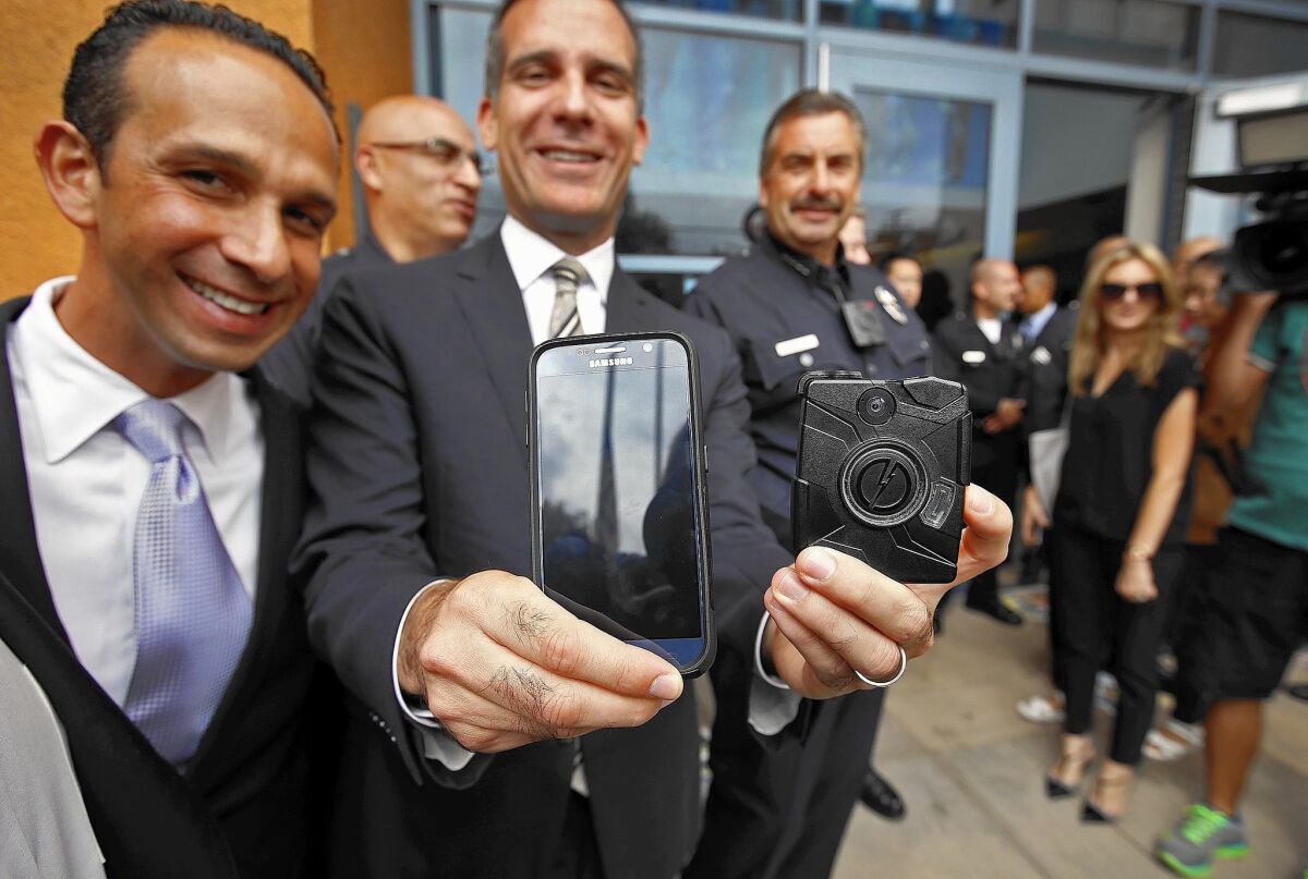 Councilman Mitch Englander, left, with Mayor Eric Garcetti, accepted campaign donations from Taser International executives. The firm is seeking an LAPD camera contract.