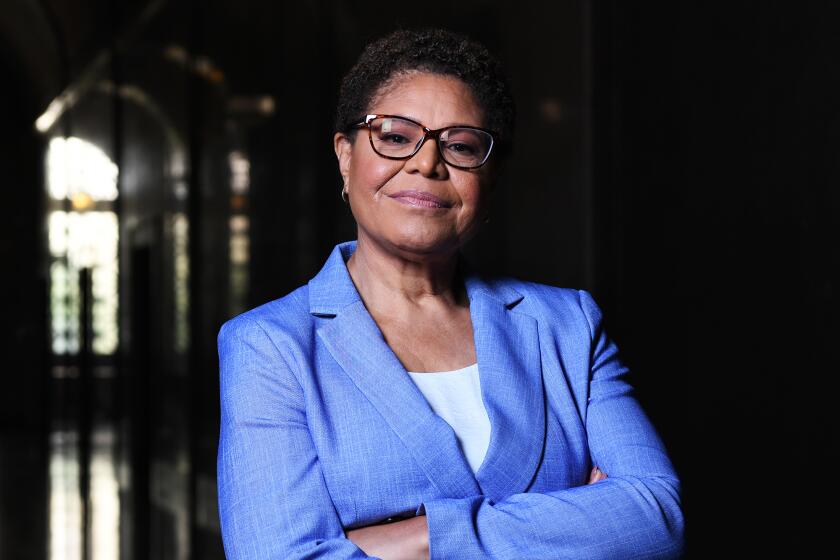 L.A. mayoral candidate Karen Bass with glasses and short hair in a light blue suit jacket