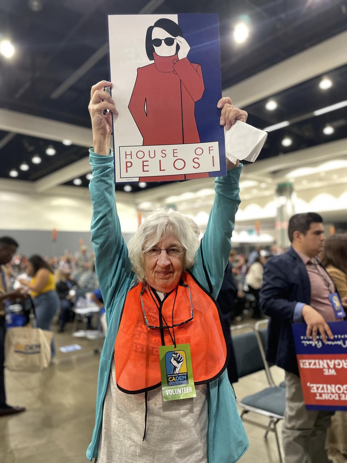 A volunteer at the California Democratic Convention celebrates former Speaker 