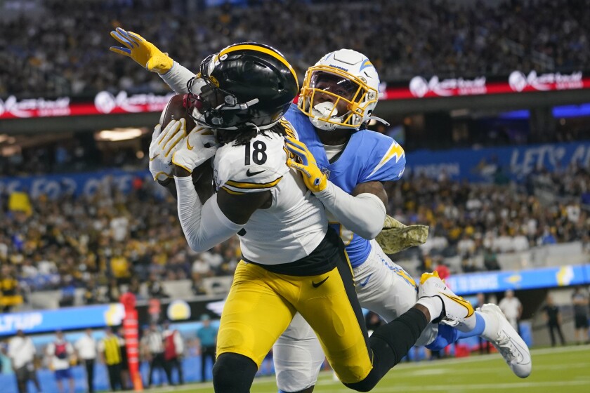 Pittsburgh Steelers wide receiver Diontae Johnson (18) makes a catch in the end zone for a touchdown as Los Angeles Chargers cornerback Asante Samuel Jr. defends during the first half of an NFL football game as Sunday, Nov. 21, 2021, in Inglewood, Calif. (AP Photo/Ashley Landis)