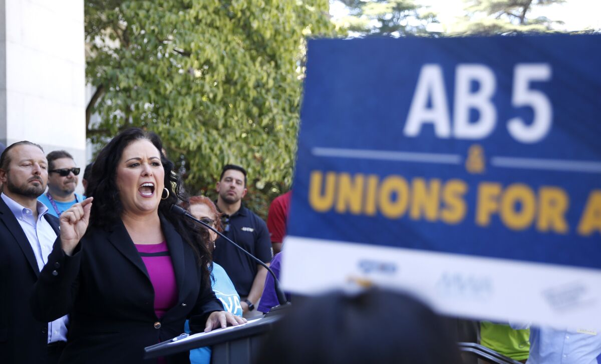 Assemblywoman Lorena Gonzalez speaks at a July rally in Sacramento after her measure to limit when companies can label workers as independent contractors was approved by a Senate committee.