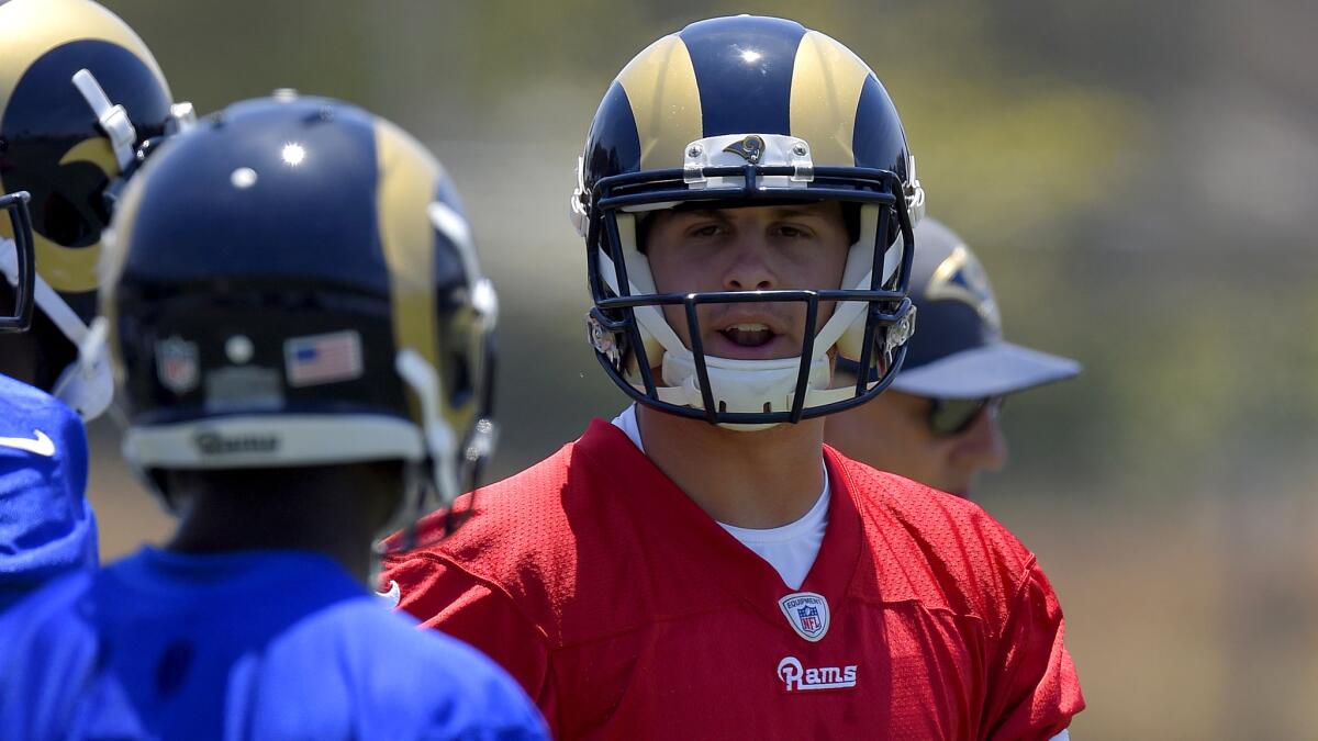 Rams quarterback Jared Goff, right, talks with wide receiver Mike Thomas during a practice session on June 3 in Oxnard.