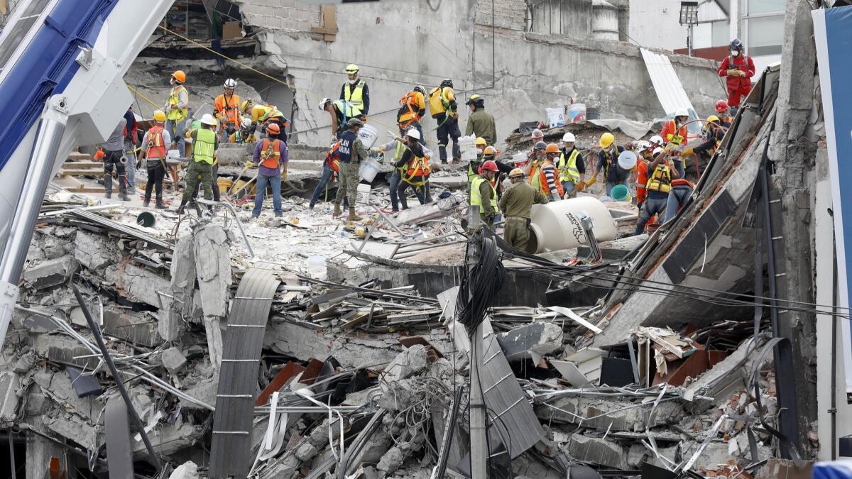 Workers continue the search for victims buried under the rubble of a fallen office building in the Condesa neighborhood of Mexico City on Sept. 24, 2017.