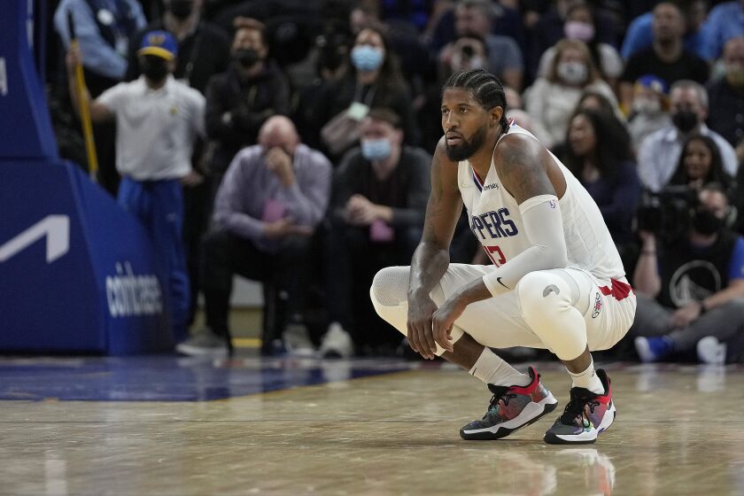 Los Angeles Clippers guard Paul George watches from the court during the second half of the team's NBA basketball game against the Golden State Warriors in San Francisco, Thursday, Oct. 21, 2021. (AP Photo/Tony Avelar)