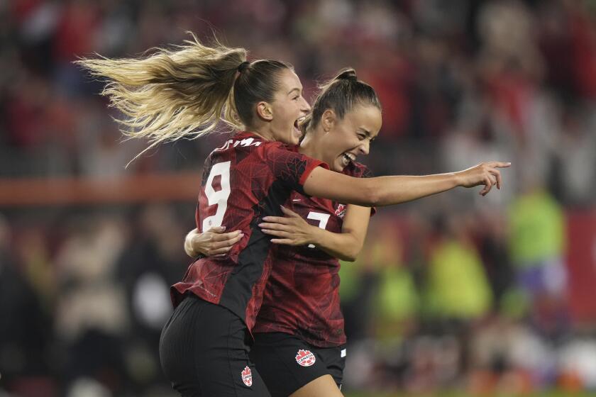 CORRECTS JULIA GROOS TO GROSSO - CORRECTS TO SECOND HALF - Canada's Jordyn Huitema (9) celebrates her goal with teammate Julia Grosso during the second half of a CONCACAF women's championship soccer series match against Jamaica in Toronto on Tuesday, Sept. 26, 2023. (Nathan Denette/The Canadian Press via AP)