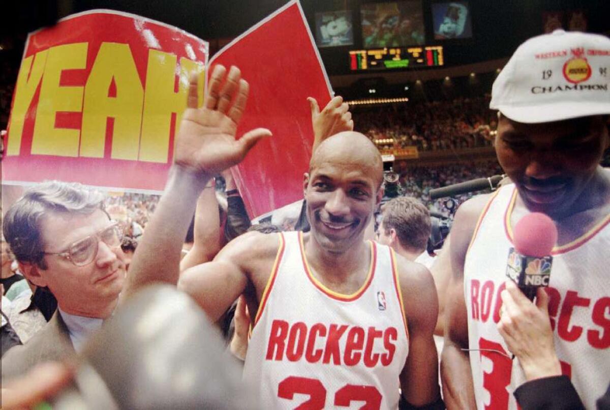 Rockets veteran Clyde Drexler, center, celebrates a win over the San Antonio Spurs to clinch the Western Conference Finals in 1995.