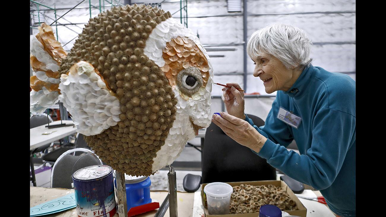 Volunteer Judith Miller works on a puffer fish for the 2018 Burbank Tournament of Roses Association float titled Sand-Sational Helpers, at the building location in Burbank on Thursday, Dec. 28, 2017.