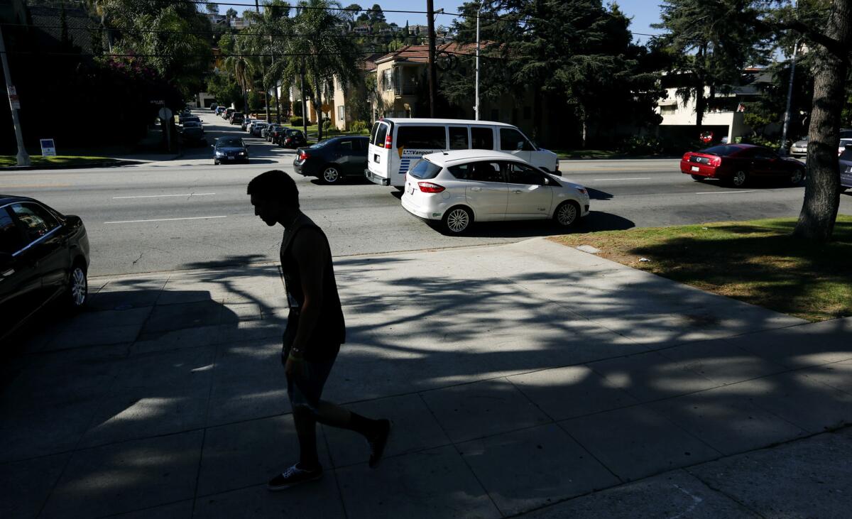 A pedestrian walks past the scene where an unarmed man was shot by police in Los Feliz in this June 2015 photo. The Los Angeles Police Commission found on Tuesday officers were justified in the shooting.