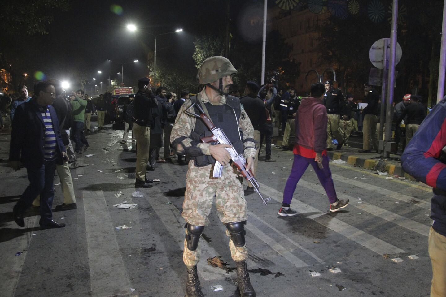 Police and security officers cordon off the area of a deadly bombing, in Lahore, Pakistan, on Feb. 13, 2017.