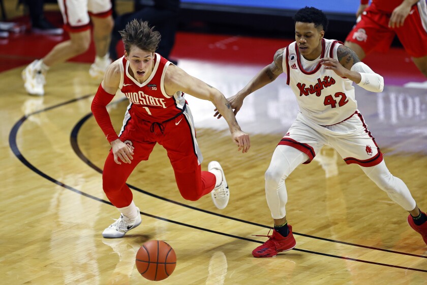 Ohio State guard Jimmy Sotos (1) chases a loose ball against Rutgers guard Jacob Young (42) during the first half of an NCAA college basketball game Saturday, Jan. 9, 2021, in Piscataway, N.J. (AP Photo/Adam Hunger)