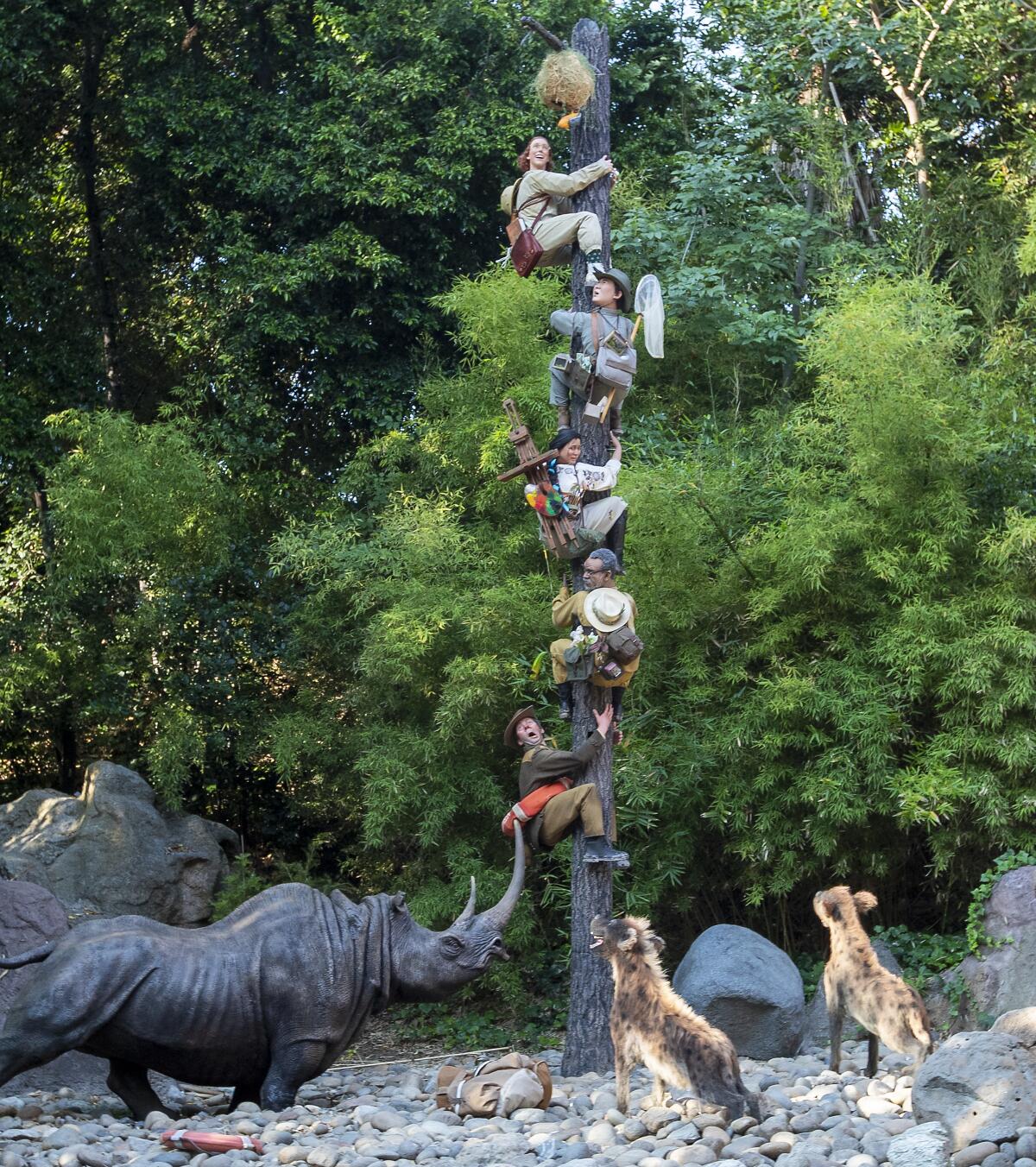 Animals have an explorer treed in a Jungle Cruise scene