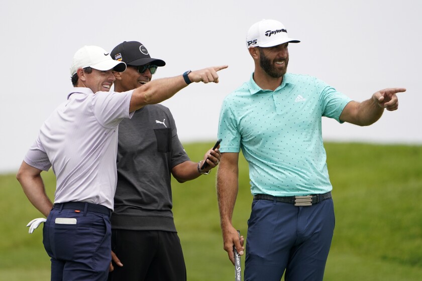 Rory McIlroy, of Northern Ireland, left, and Dustin Johnson, right, point from the second tee box during a practice round of the U.S. Open Golf Championship, Wednesday, June 16, 2021, at Torrey Pines Golf Course in San Diego. (AP Photo/Jae C. Hong)