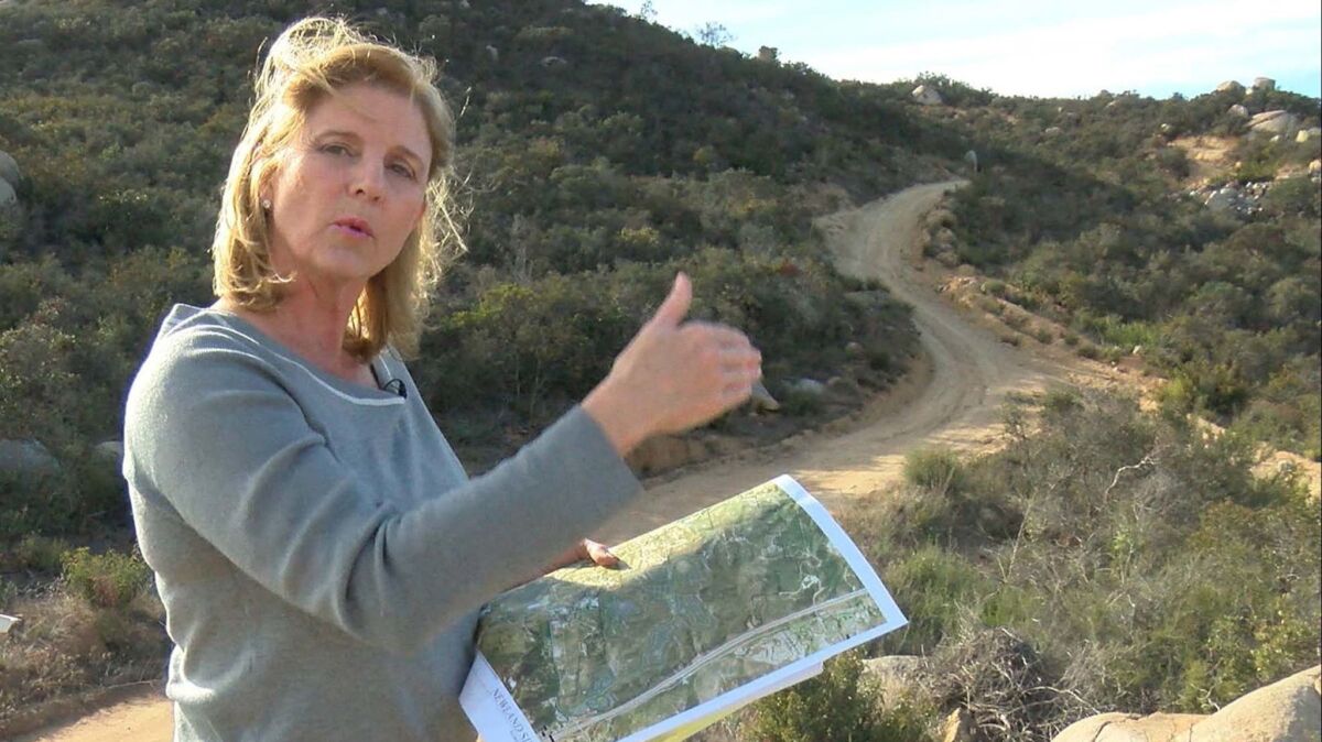 Escondido CA.- March 5, 2018,- Rita Brandin, Sr. VP ad Development Director for Newline Sierra, with a map near the high point of the property. The 1,800 acres of the proposed Newland Sierra development project is in the Twin Oaks area north of Escondido.
