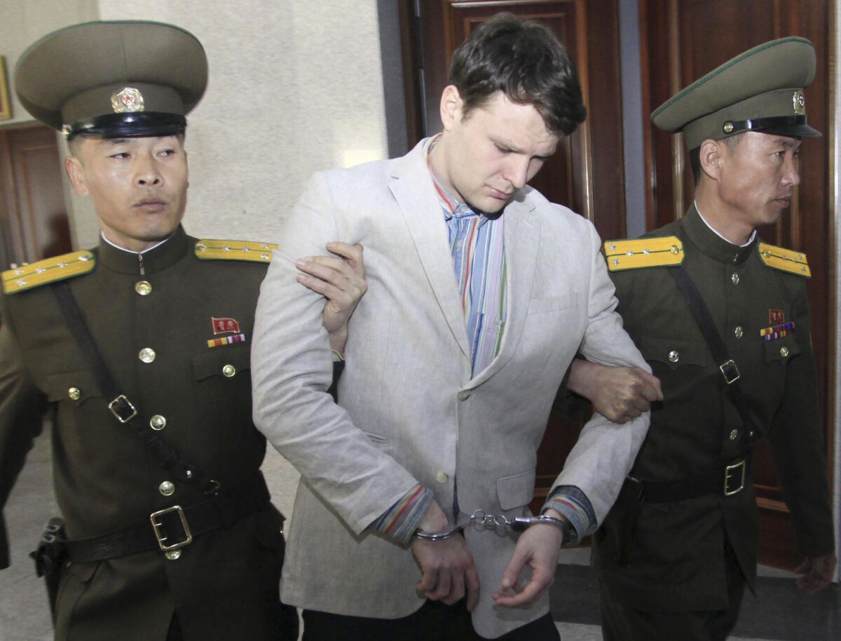 American student Otto Warmbier is escorted by guards into the Supreme Court in Pyongyang, North Korea, on March 16, 2016.