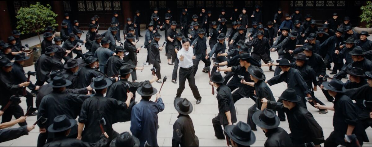 Ip Man (Dennis To) stands at the center of about 100 guys with axes in "Ip Man: Kung Fu Master."