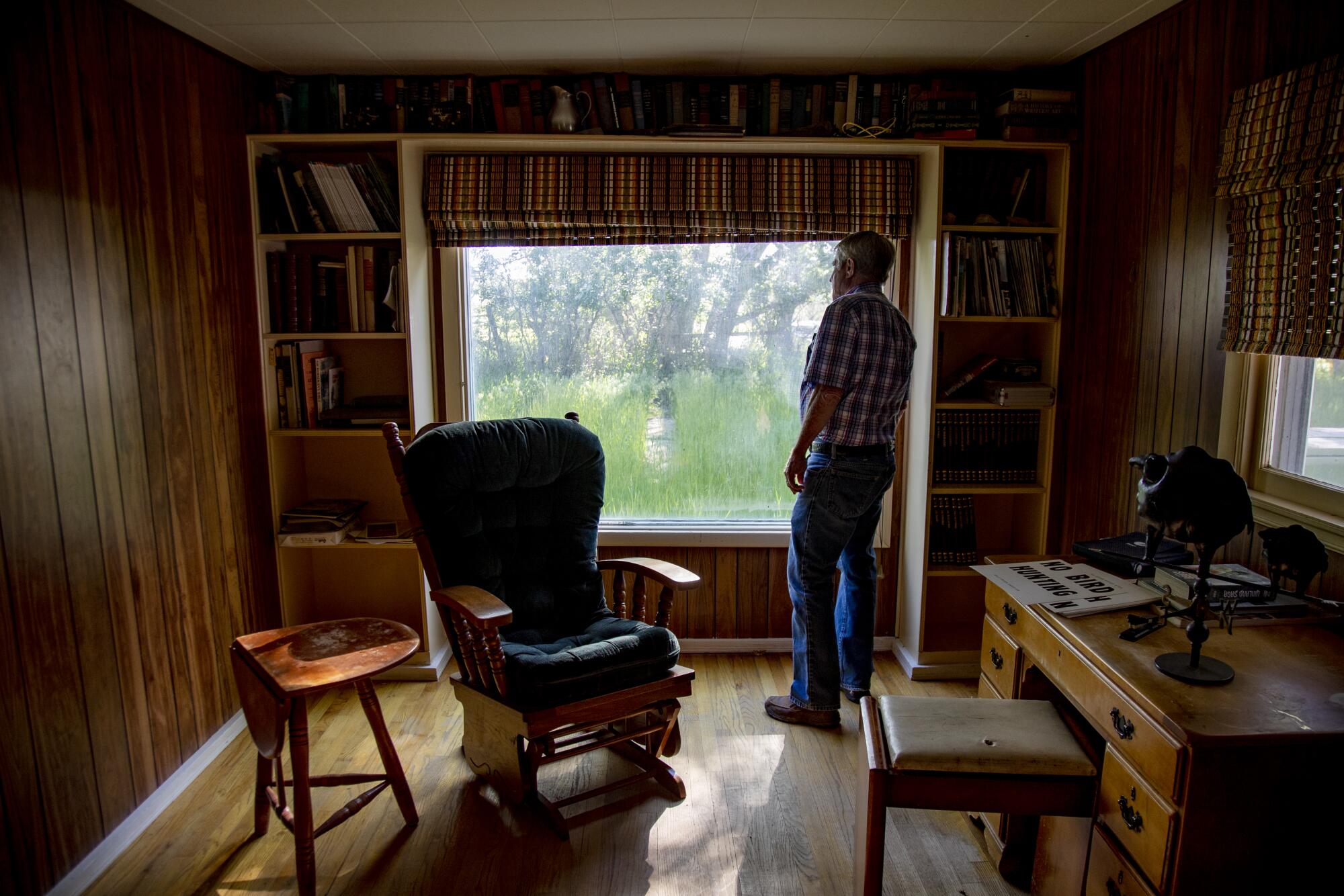 Jon Nicolaysen stares out the window of his home