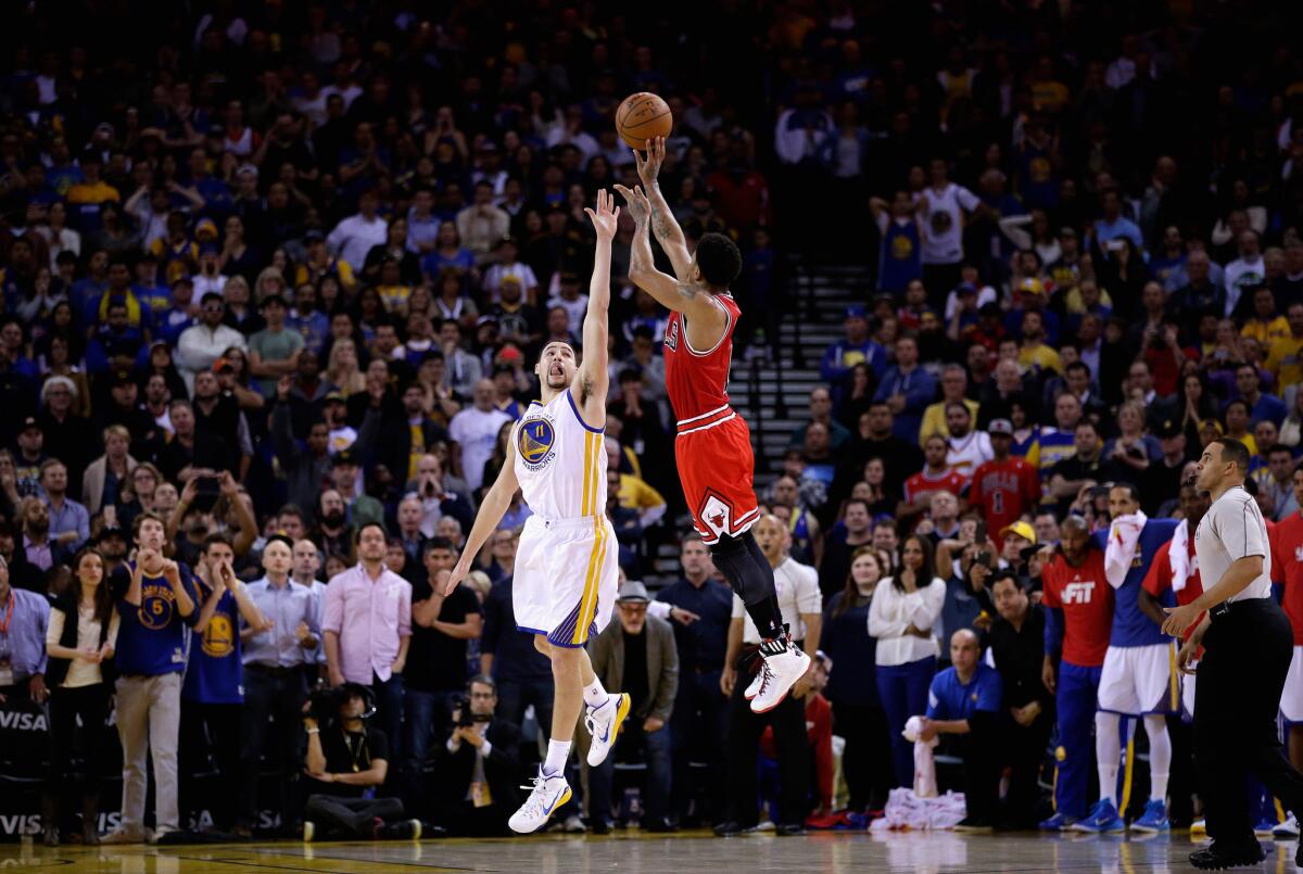 Chicago's Derrick Rose puts up the game-winning shot over Golden State's Klay Thompson in overtime to give the Bulls a 113-111 win and end the Warriors' 19-game home win streak.