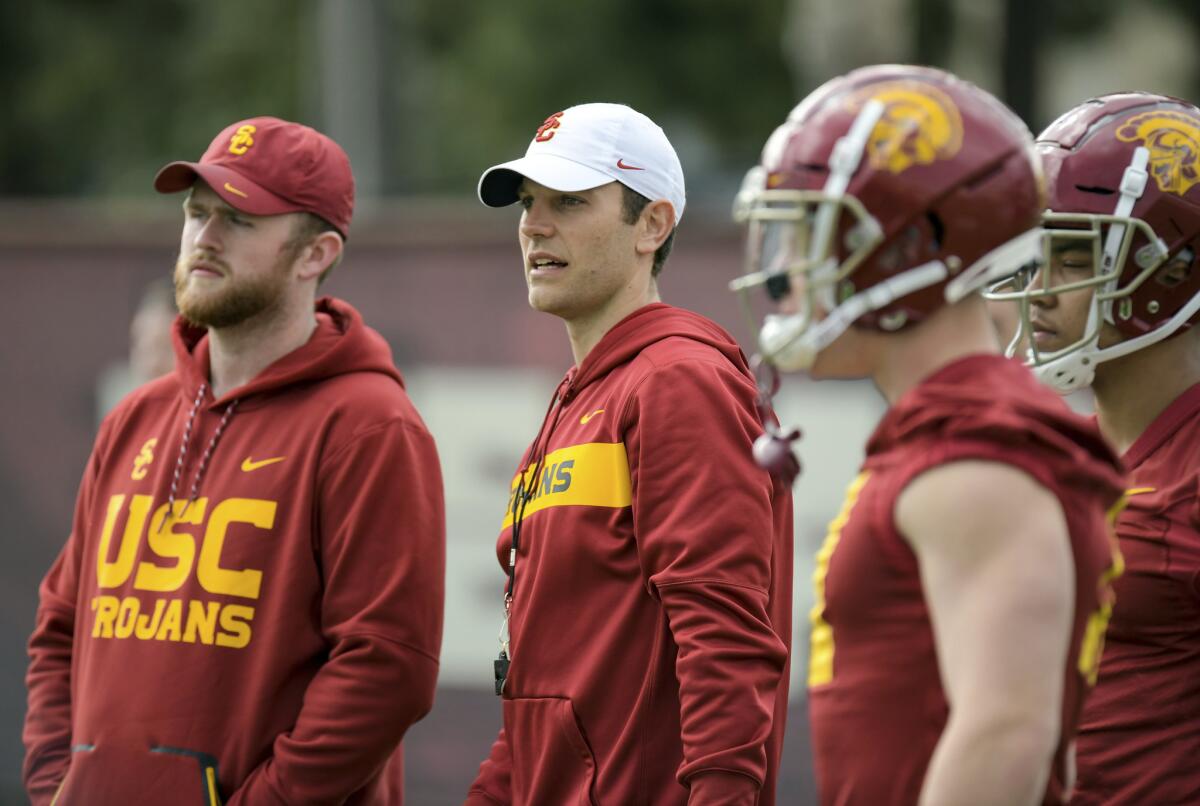 USC offensive coordinator Graham Harrell, center, watches the Trojans work out during a spring practice.