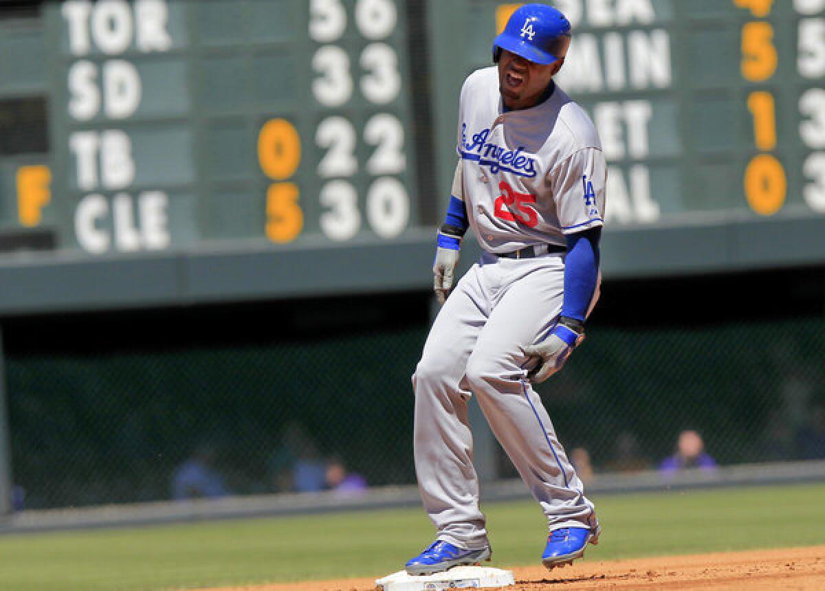 Dodgers' Carl Crawford (25) comes up lame after hitting a double against the Colorado Rockies.