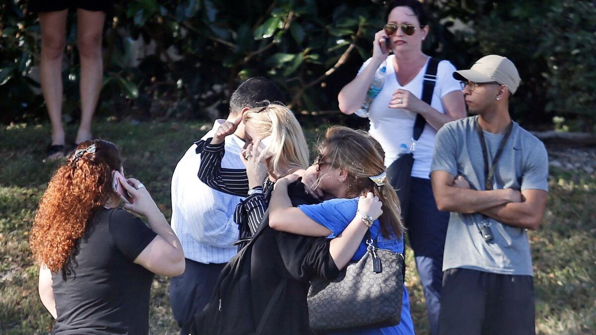 Anxious family members wait for news of students in Parkland, Fla., after the shooting at Marjory Stoneman Douglas High School.