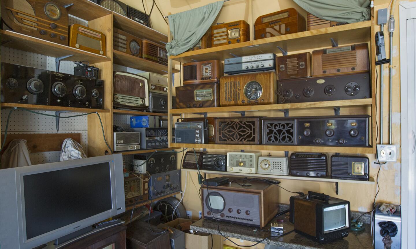 Vintage radios fill a corner in John Eng's garage at his home in La Palma. (Kevin Chang/ Times OC)