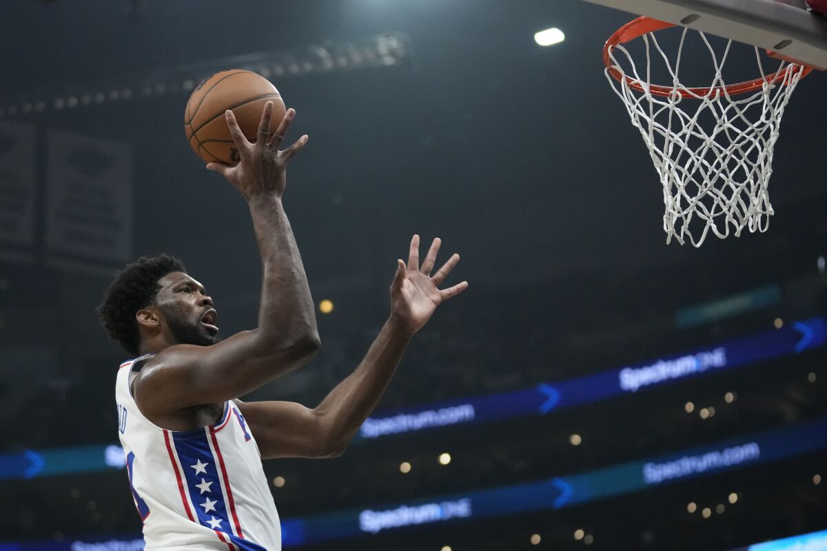 Philadelphia 76ers center Joel Embiid shoots during the first half against the Clippers.