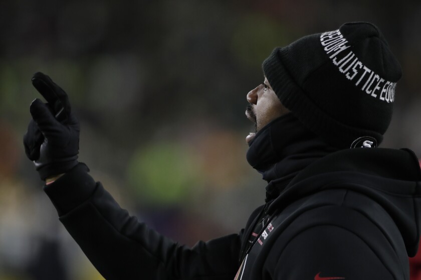 San Francisco 49ers defensive coordinator DeMeco Ryans watches warm ups before an NFC divisional playoff NFL football game against the Green Bay Packers Saturday, Jan. 22, 2022, in Green Bay, Wis. (AP Photo/Aaron Gash)
