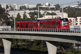 SAN DIEGO, CA - OCTOBER 14: A trolley on the MTS Mid-Coast Extension Blue Line heads away from the UC San Diego central campus stop toward UTC on Thursday, Oct. 14, 2021 in San Diego, CA. (K.C. Alfred / The San Diego Union-Tribune)