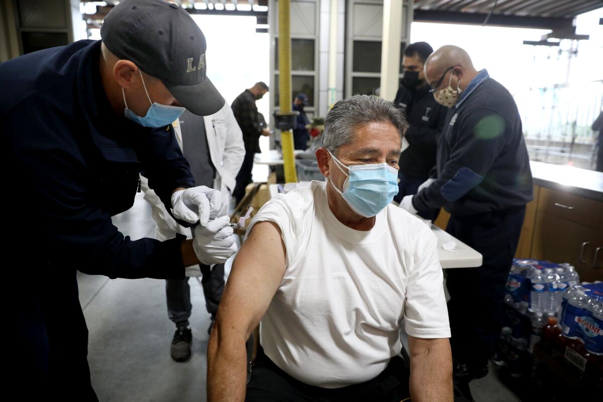 LAFD fire inspector Gabriel Orona gets a shot.