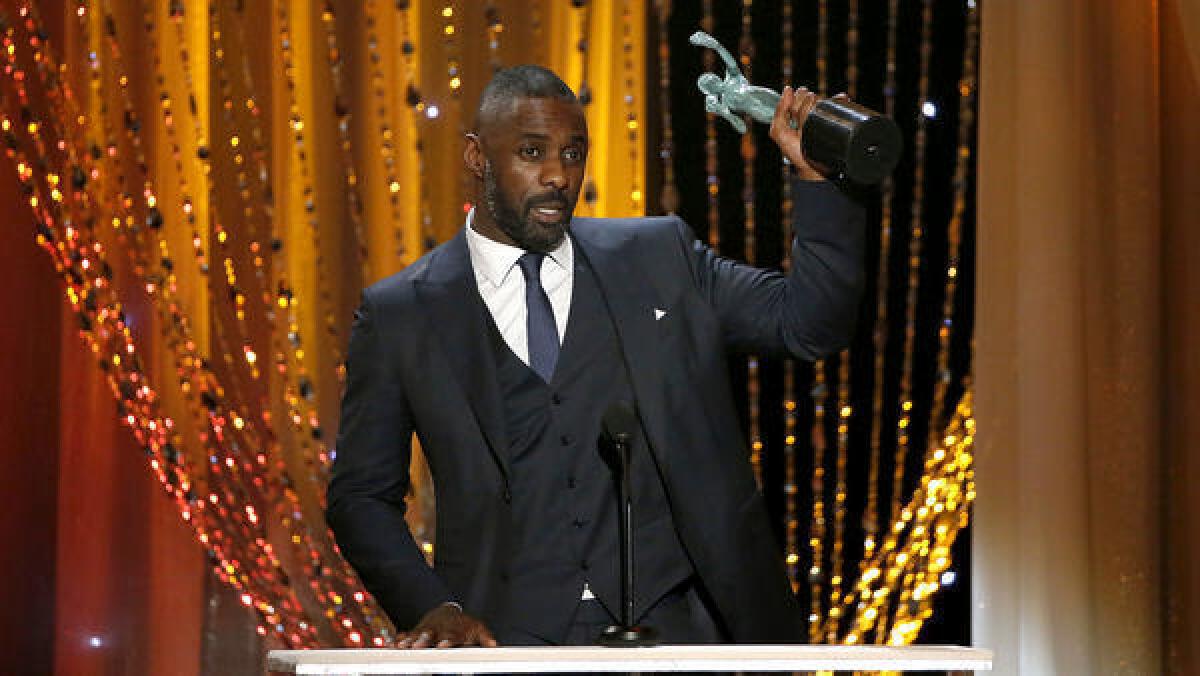 Idris Elba with one of the two statues he won at the Screen Actors Guild Awards.