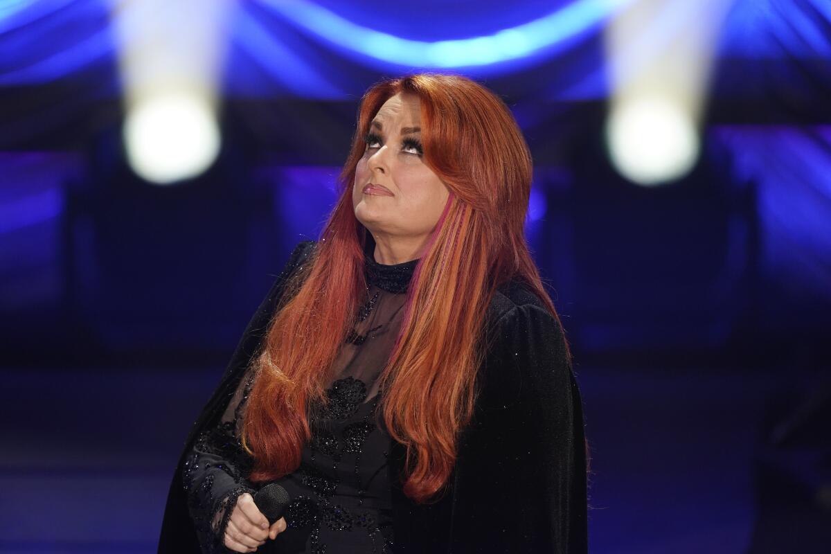 Wynonna Judd looks up after singing during a tribute to her mother, country music star Naomi Judd, Sunday, May 15, 2022, in Nashville, Tenn. Naomi Judd died April 30. She was 76. (AP Photo/Mark Humphrey)