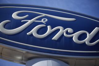 FILE - A Ford company logo on a sign at a Ford dealership in southeast Denver, Oct. 24, 2021. (AP Photo/David Zalubowski, File)