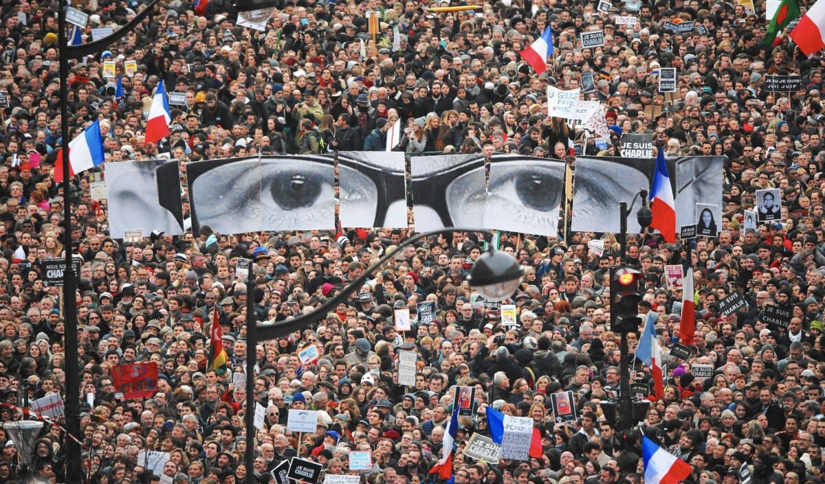 Demonstrators in Paris carried banners representing Stephane Charbonnier, known as Charb, the slain editor of Charlie Hebdo.
