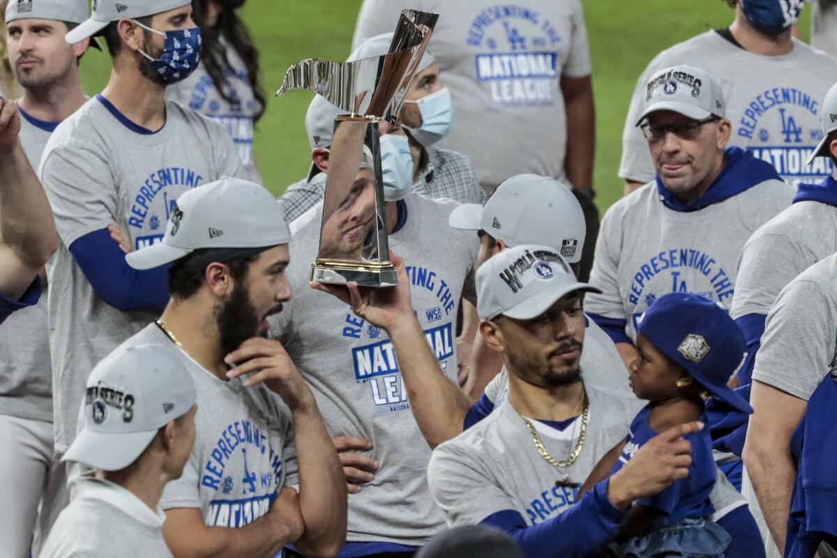 The Warren C. Giles NLCS trophy is handed around by players.