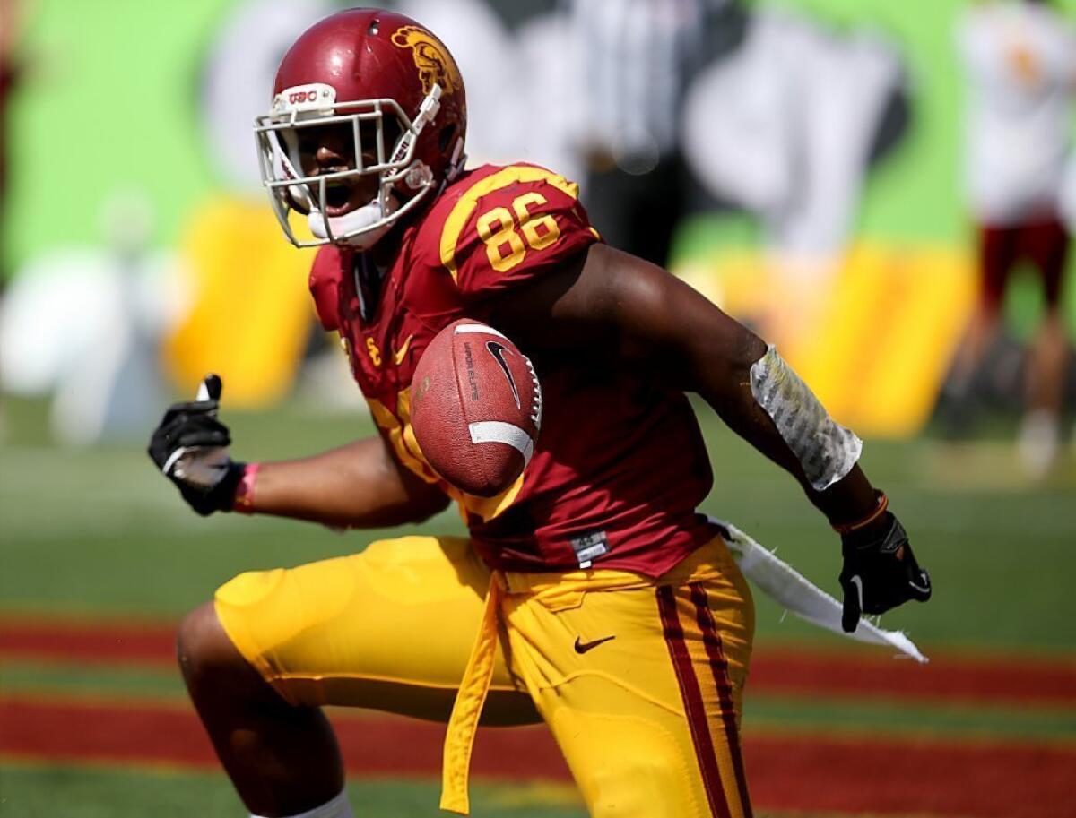 USC tight end Xavier Grimble celebrates a touchdown catch and run against Utah State on Sept. 21.