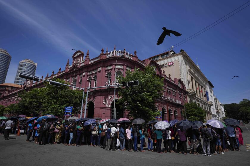 People queue up to enter the official residence of president Gotabaya Rajapaksa three days after it was stormed by anti government protesters in Colombo, Sri Lanka, Tuesday, July 12, 2022. Rajapaksa had vacated the building before the protesters came in. (AP Photo/Eranga Jayawardena)
