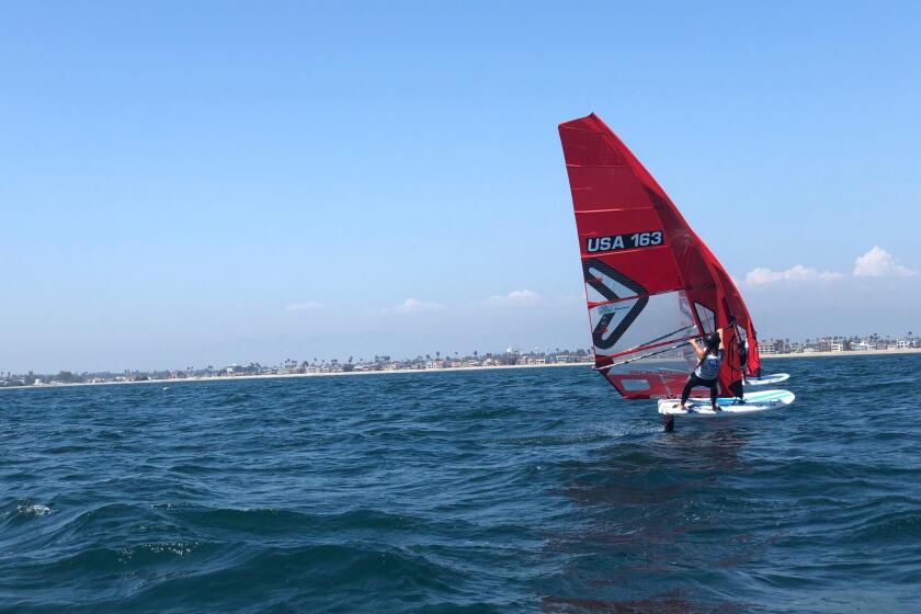 A competitor adjusts a sail in Long Beach Friday.