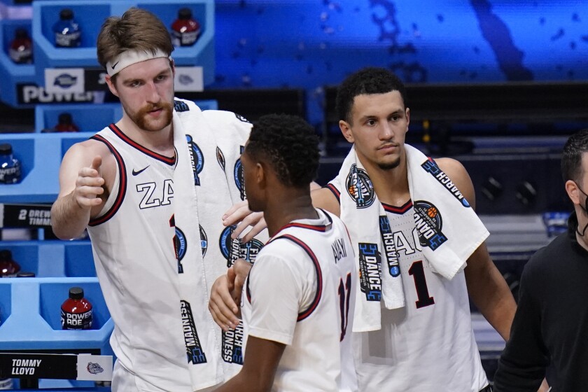 Gonzaga forward Drew Timme and Jalen Suggs greet Joel Ayayi.