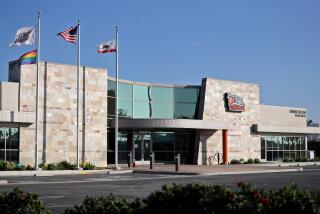 Four flags, including the American, California, OCFEC and the LGBTQ flags, fly over the O.C. Fair & Event Center administration building, in Costa Mesa on Thursday, Nov. 19, 2020. Some locals say it is non-inclusive to have the LGBTQ flag flying without extending the same offer to other area groups and affiliations.