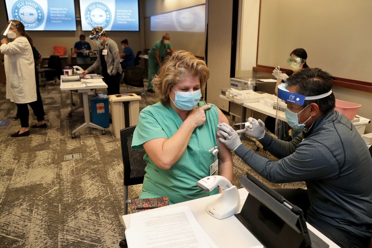 Emergency room doctor Paula Gonella receives her first dose.
