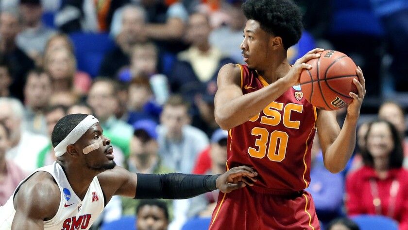USC guard Elijah Stewart weighs his options as he's defended by SMU guard Ben Emelogu II during the first half Friday night.