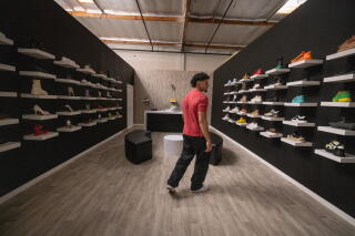 Head production manager Ruben Ortiz looks at shelves at Burbank-based Dhar Mann Studios