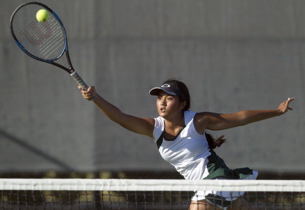 Costa Mesa High's Caitlin Wase returns the ball at the net during a No. 1 doubles set against Estancia.