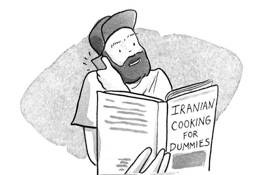 A man with an "Iranian Cooking for Dummies" book on the phone ordering two pizzas.