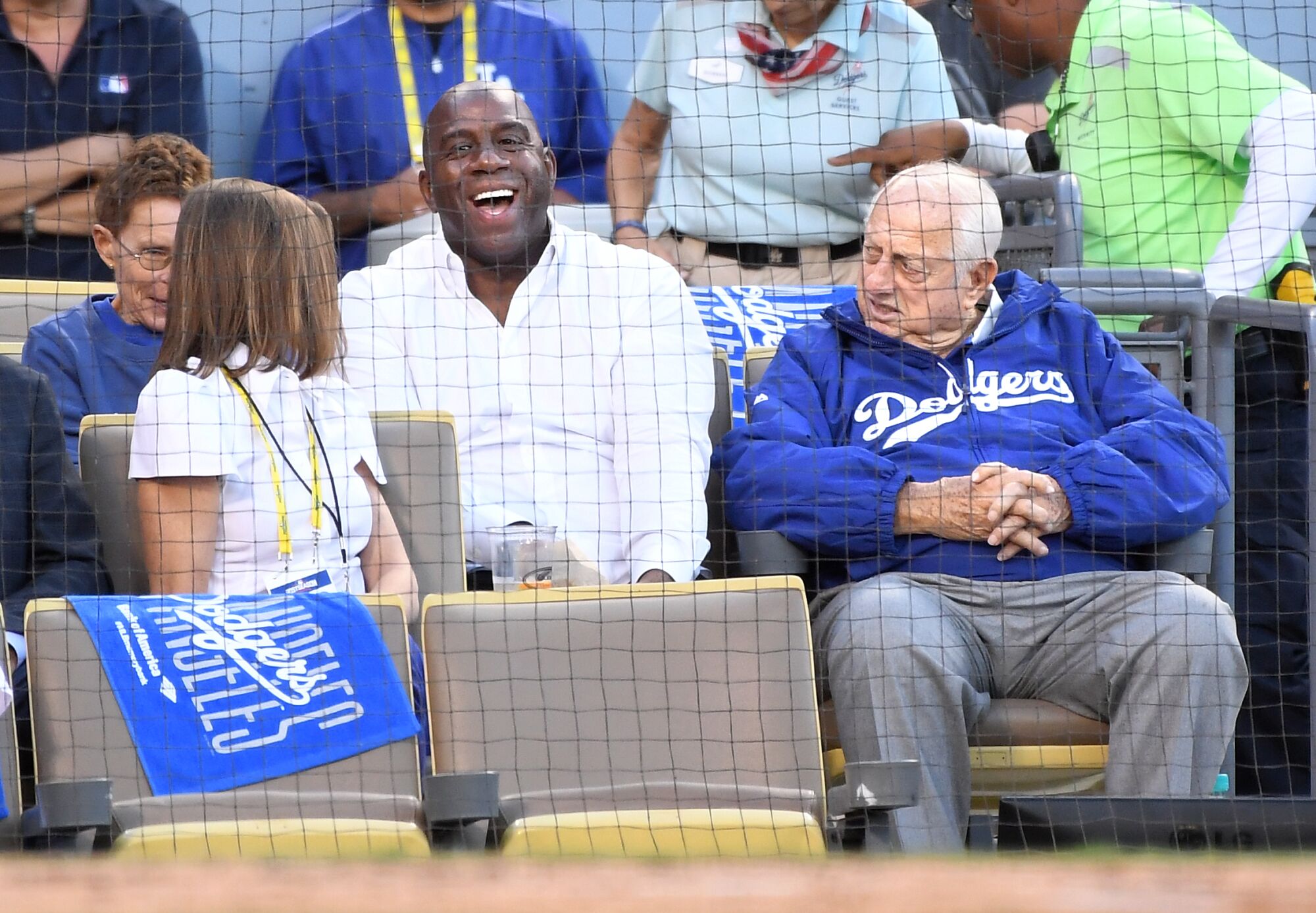 Dodgers executive Magic Johnson sits with Tommy Lasorda at a 2016 playoff game between the Dodgers and Chicago Cubs 