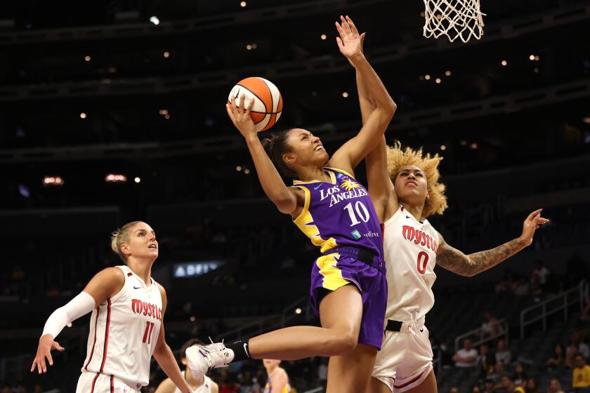 LOS ANGELES, CALIFORNIA - JULY 12: Olivia Nelson-Ododa #10 of the Los Angeles Sparks goes up for a shot against Shakira Austin #0 of the Washington Mystics in the first half at Crypto.com Arena on July 12, 2022 in Los Angeles, California. NOTE TO USER: User expressly acknowledges and agrees that, by downloading and or using this photograph, User is consenting to the terms and conditions of the Getty Images License Agreement. (Photo by Katharine Lotze/Getty Images)