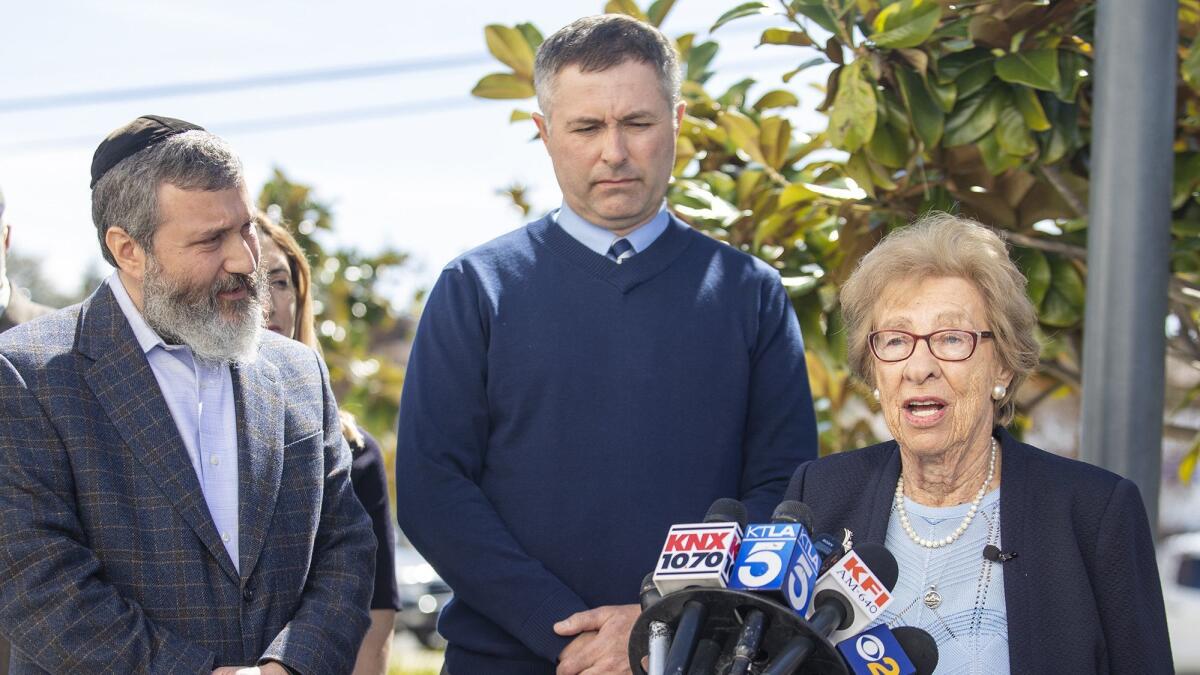 Eva Schloss is joined by Rabbi Reuven Mintz, left, and Newport Harbor High School Principal Sean Boulton during a news conference Thursday at the school.