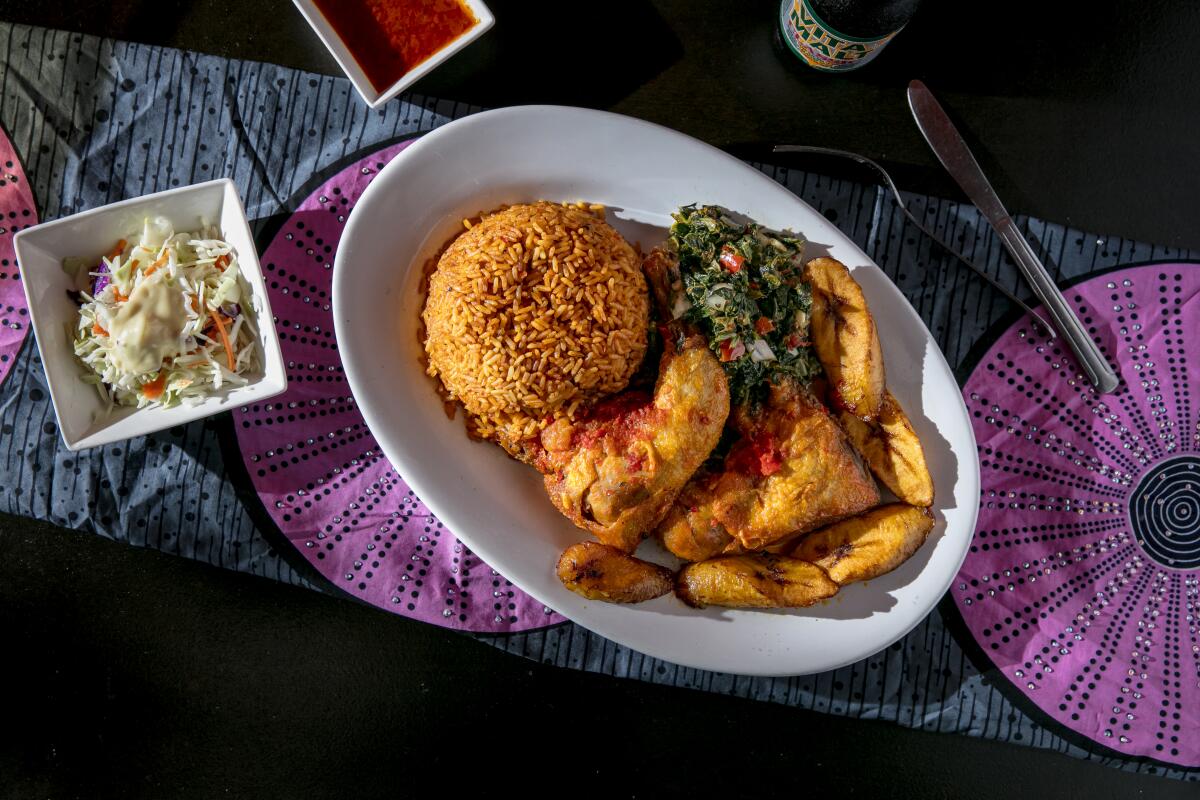 The jollof rice combo with fried chicken, plantains, spinach and a side of cole slaw at Aduke African Cuisine.