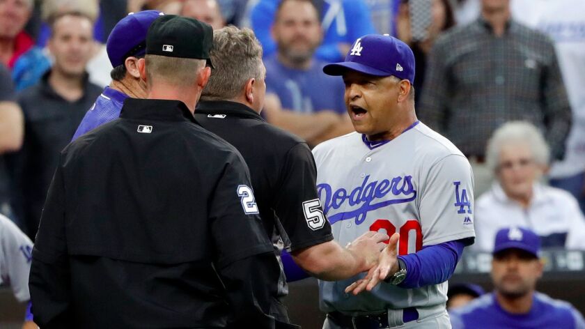 Los Angeles Dodgers manager Dave Roberts, right, speaks to home plate umpire Greg Gibson after an argument during the second inning of the team's baseball game against the San Diego Padres on Friday, June 30, 2017, in San Diego. (AP Photo/Gregory Bull)